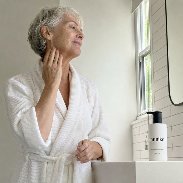 Smoothing lotion onto the neck after a shower