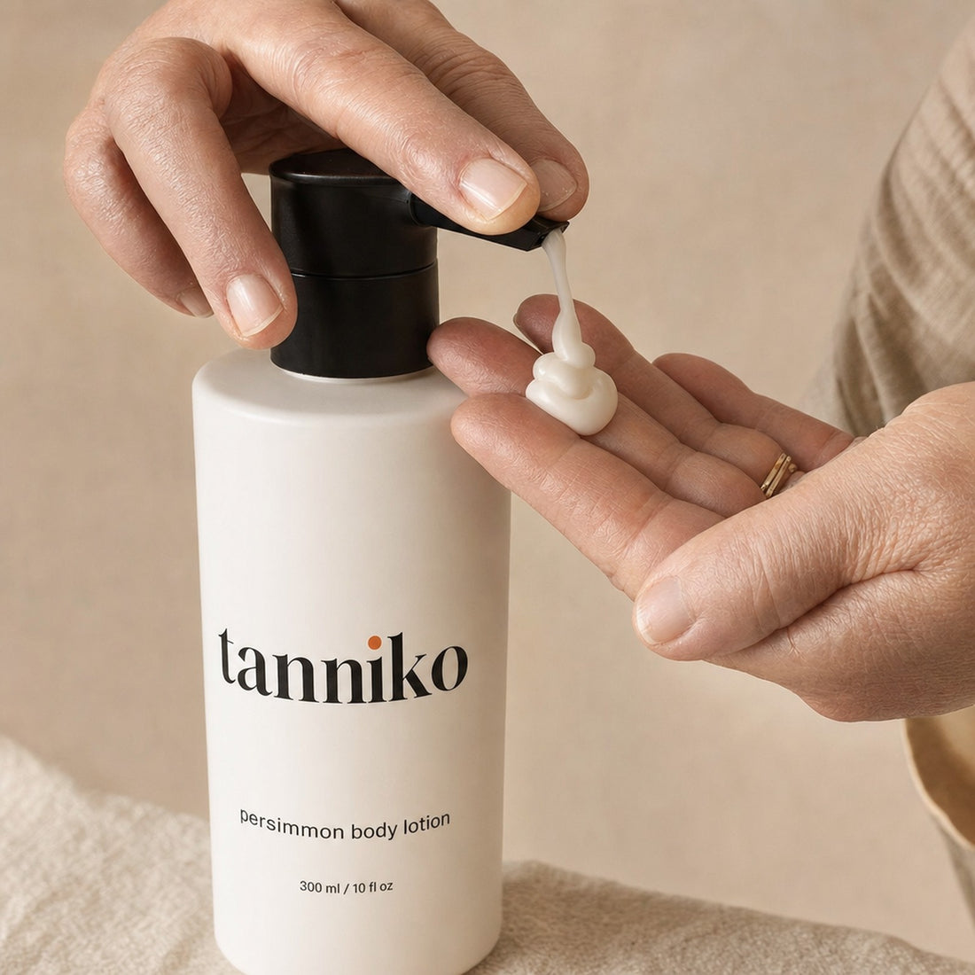 Light cream texture of Tanniko persimmon body lotion in the palm
